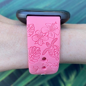 May include: Pink silicone watch band with a tropical floral and sea turtle design.