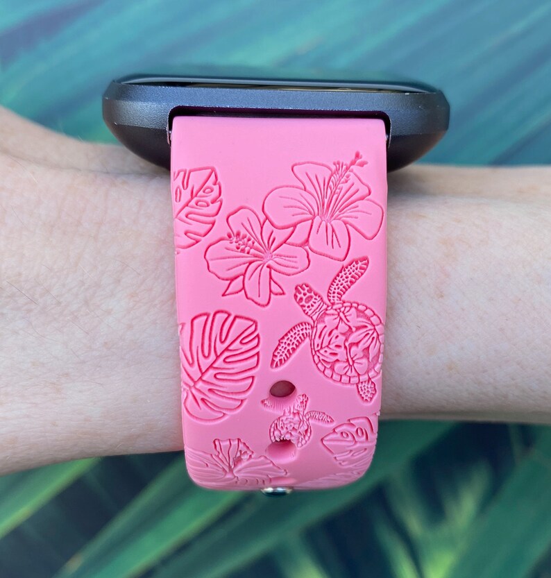 May include: Pink silicone watch band with a tropical floral and sea turtle design.