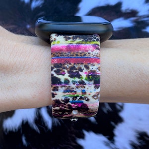 May include: A colorful watch band with a leopard print and stripes. The band is made of silicone and is compatible with Apple Watch.