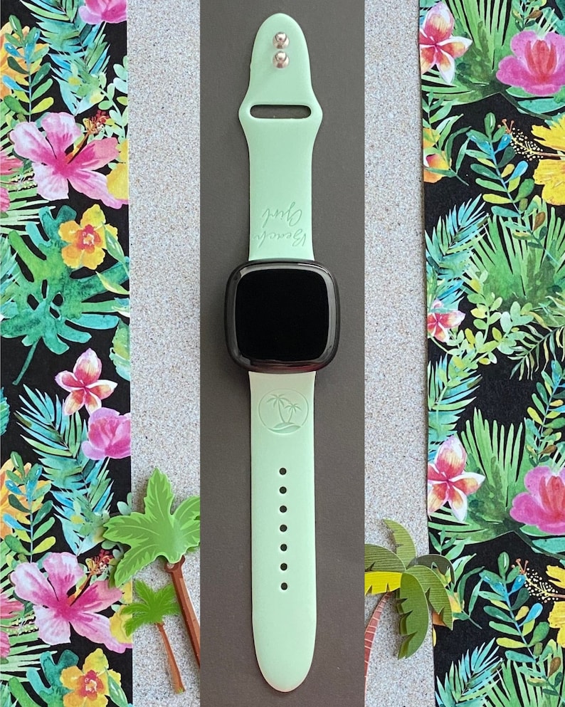 May include: A light green silicone watch strap with a palm tree design and the text "Beach Vibes" on it. The strap is compatible with a smartwatch.