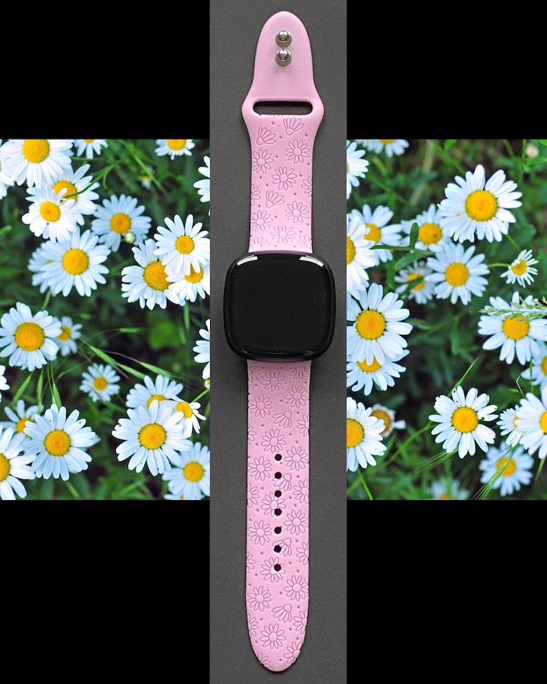 May include: Pink silicone watch band with a daisy pattern. The band is compatible with smartwatches.