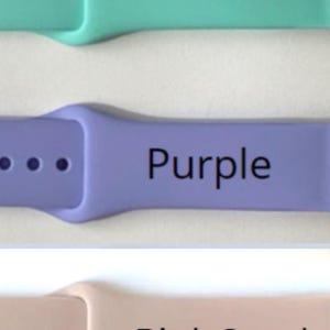 May include: Three Apple Watch bands in different colours: teal, purple, and pink sand. Each band has a row of small holes for adjusting the fit.