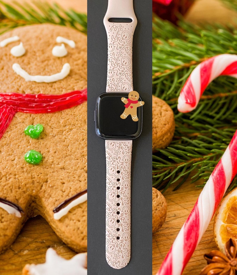 May include: A pink smartwatch band with a gingerbread man pattern. The band is on a black background and there are gingerbread cookies and candy canes in the background.
