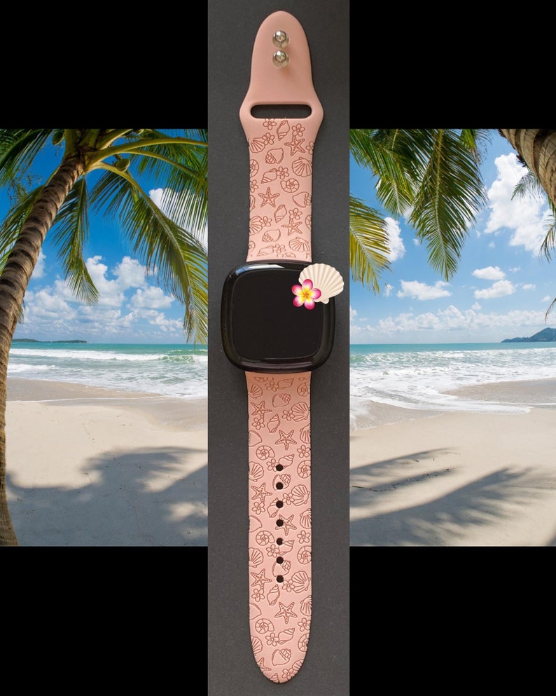 May include: A pink silicone watch band with a seashell and starfish pattern. The band is shown on a black background with a smartwatch face.