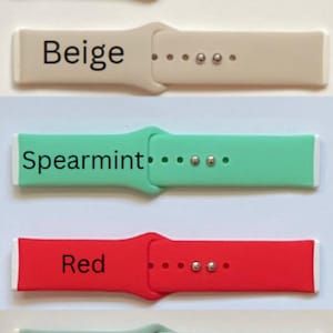 May include: Five different coloured silicone watch straps. The straps are light blue, beige, spearmint, red, and blue green.