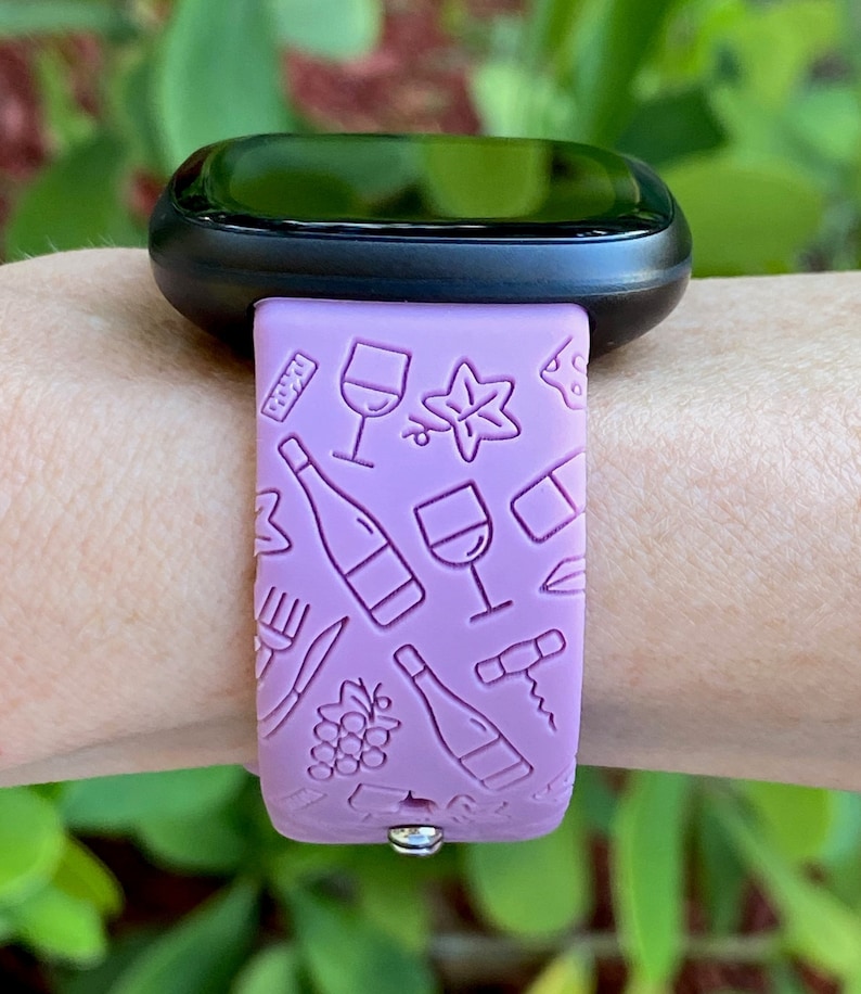 May include: A purple silicone watch band with a wine-themed design. The band features images of wine bottles, glasses, grapes, and corkscrews.