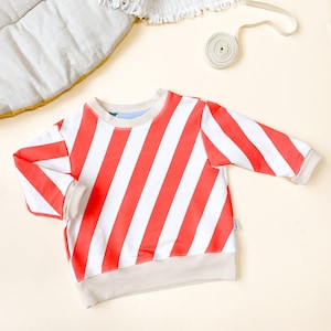 striped sweater red cream, sweater striped white red, striped sweater red white, sweater with stripes, diagonal stripes sweater child