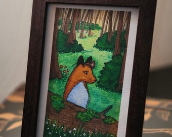 Puede incluir: Pintura de acuarela enmarcada de un zorro en un bosque. El zorro tiene pelaje naranja, pecho blanco y sombrero negro. El fondo presenta árboles, hierba y flores. La obra de arte se presenta en un marco de madera marrón oscuro.