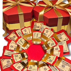 May include: Red and gold gift box with a money explosion inside. The box is decorated with a gold ribbon and has a hexagonal shape. The money is in red envelopes with gold trim. The text "MONEY NOT INCLUDED" is printed at the top of the image.