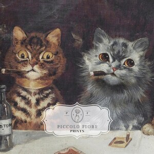 May include: A painting of two cats, one brown tabby and one grey, sitting at a table with a glass of wine and a lit cigar. The cats are both looking at the viewer. The painting is titled "Piccolo Fiore Prints".