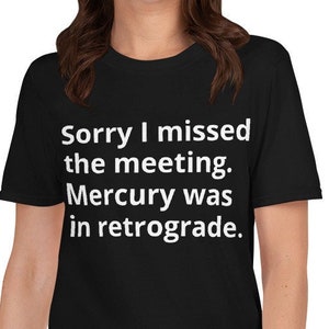 Puede incluir: Camiseta negra con texto blanco que dice "Lo siento, me perdí la reunión. Mercurio estaba retrógrado."