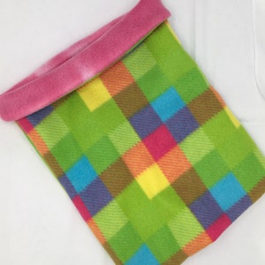 May include: A colorful plaid fleece pet bed with a pink fleece lining. The bed is made of soft, comfortable fabric and is perfect for small pets.