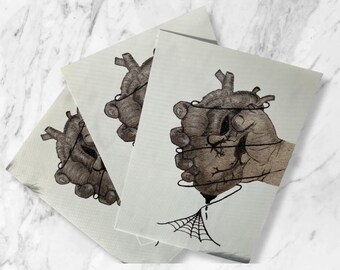 May include: Three prints of a hand holding a heart wrapped in barbed wire. The heart is dripping blood onto a spider web.