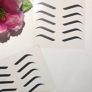 May include: Three sheets of clear plastic with black eyebrow stencils. Each sheet has six different eyebrow shapes.