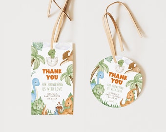 May include: Two dinosaur-themed thank you tags for a baby shower. The tags are printed on white cardstock with a green, brown, and blue watercolor design. The text on the tags reads "Thank You for showering us with love Jessica's Baby Shower 04.23.XX".