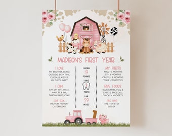 Könnte beinhalten: Ein rosa-weißes Bauernhof-First-Birthday-Meilenstein-Poster mit einem rosa Scheunen, einer Kuh, einem Schwein und einem Traktor. Das Poster enthält Details über das erste Jahr des Kindes, wie Gewicht, Größe und Lieblingsessen. Der Text auf dem Poster lautet "Madison's First Year".