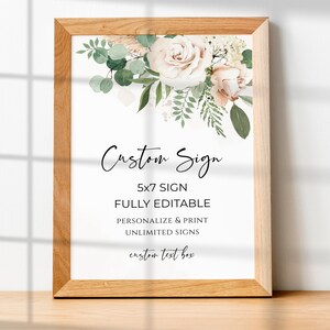 May include: A printable 5x7 inch sign with a floral design featuring blush pink roses and greenery. The text reads "Custom Sign", "5x7 Sign", "Fully Editable", "Personalize & Print", "Unlimited Signs", and "Custom Text Box".