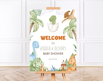 Könnte beinhalten: Willkommensschild für eine Babyparty mit Aquarellillustrationen von Dinosauriern, Palmen und Blättern. Auf dem Schild steht "Willkommen zur Babyparty von Jessica & Oliver" mit dem Datum 04.23.XX in Orange und Grün.
