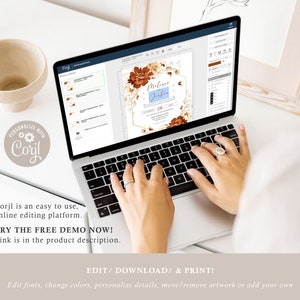 May include: A laptop computer displaying a wedding invitation template on the screen. The invitation features a floral design with brown and white flowers and a gold hexagon frame. The text on the invitation reads "Melissa & Joshua" and "28".