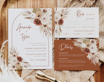 May include: Wedding invitation suite with a boho theme. The invitation features a white background with a brown archway and a floral arrangement of dried grasses, pampas grass, and flowers in shades of brown, beige, and white. The text reads "Amanda + Tyler" and includes the wedding date, time, and location. The RSVP card features a similar floral design and includes options for accepting or declining the invitation, as well as meal choices. The details card features a brown background with a floral design and includes information about transportation and accommodation.