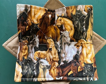 May include: A quilted bowl cozy featuring a horse print with various colors of brown, black, and white horses. The cozy is made of fabric and has a tan-colored exterior. The cozy is designed to hold a bowl and keep food warm.