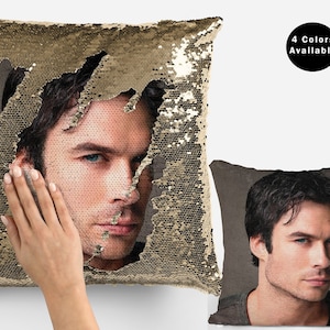 May include: A gold sequin pillow with a reversible image of a man's face. The image is hidden when the sequins are flipped to reveal a solid gold color.  The pillow is 4 Colors Available.