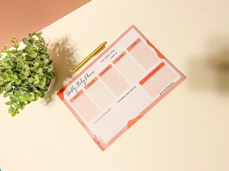 Puede incluir: Un planificador de estudios semanal rosa y blanco con secciones para cada d&iacute;a de la semana, citas motivacionales y espacio para objetivos y recordatorios. El planificador tiene el t&iacute;tulo escrito a mano "Weekly Study Planner" y el texto "This week's goal" y "It's the weekend!"