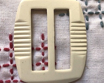 Rectangular white carved casein belt slide 1930's Art Deco