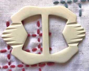 Small white carved casein belt slide Art Deco