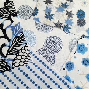 May include: Assortment of blue and white patterned fabric squares. The patterns include a floral design, a swirling pattern, a polka dot pattern, and a geometric pattern.