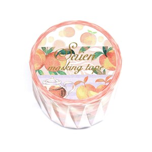May include: A roll of decorative masking tape with a peach and tea theme. The tape features watercolour illustrations of peaches, leaves, and a teapot. The text "Saien masking tape" is printed in gold.