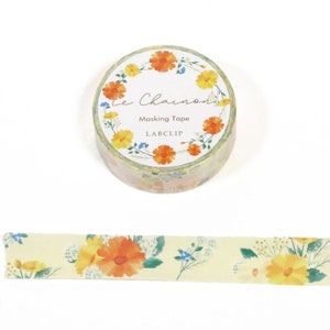May include: A roll of yellow floral washi tape with a floral wreath design. The tape is labeled "Le Chamomile Masking Tape LABCLIP".