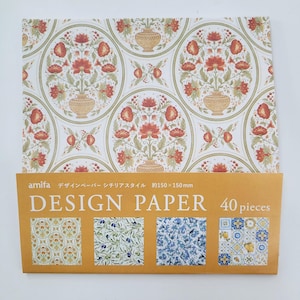 May include: A pack of 40 design papers featuring four different patterns. The patterns include a floral design with red flowers and green leaves, a pattern of olive branches and leaves, a blue and white tile pattern, and a yellow and blue tile pattern. The pack is labeled "Design Paper" and "40 pieces".