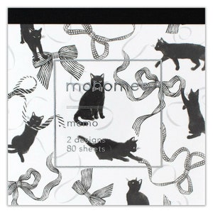 May include: A memo pad with a black and white design featuring black cats and silver ribbon bows. The text "monome memo" and "2 designs 80 sheets" is printed on the front.