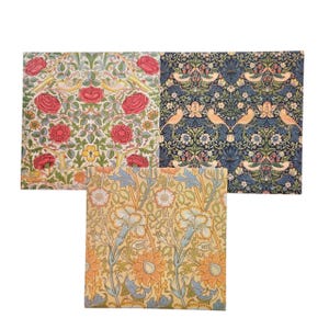 May include: Three fabric squares with floral patterns. One has red roses, yellow flowers, and birds on a white background. Another has a blue background with birds and floral designs. The third has a yellow background with orange and blue floral patterns.