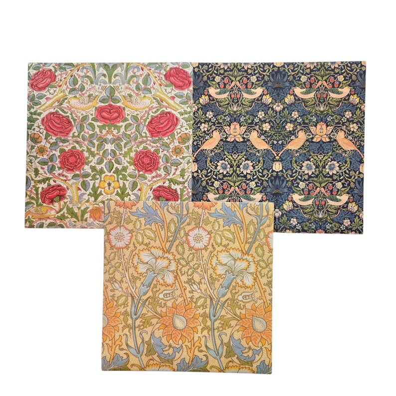 May include: Three fabric squares with floral patterns. One has red roses, yellow flowers, and birds on a white background. Another has a blue background with birds and floral designs. The third has a yellow background with orange and blue floral patterns.