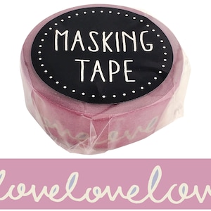 May include: Pink washi tape with the words "love love love" printed on it. The tape is rolled up and has a black label that says "masking tape".