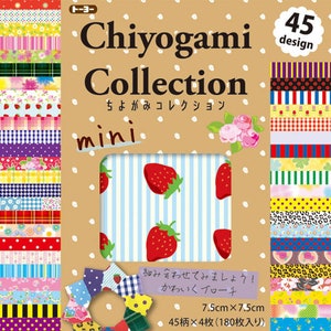 May include: A Chiyogami Collection mini set featuring 45 designs of patterned paper strips. The packaging includes a window showcasing a strawberry design. The set includes 180 sheets, each 7.5cm x 7.5cm.