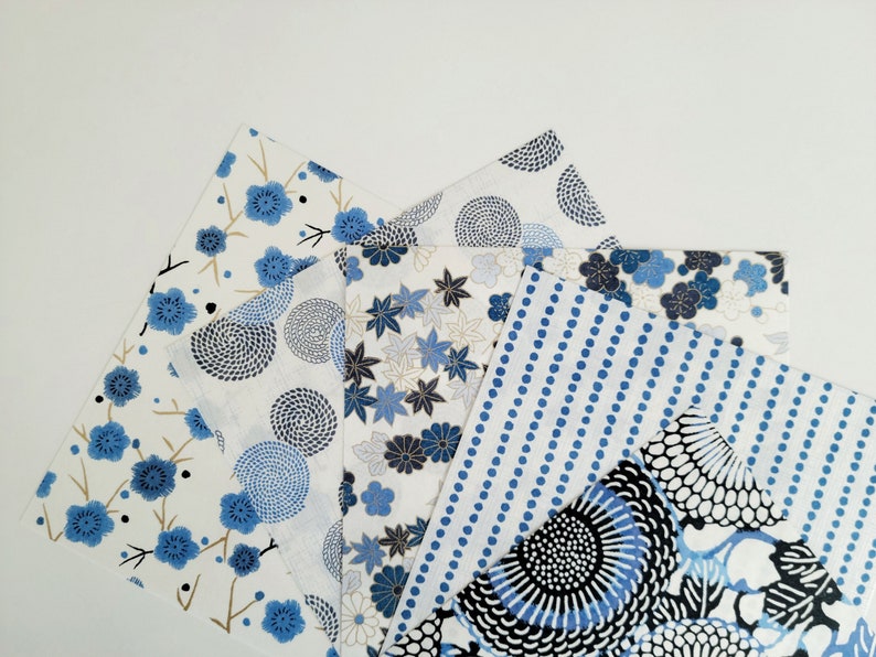 May include: Four different fabric squares with blue and white patterns. The patterns include floral designs, circles, and stripes.