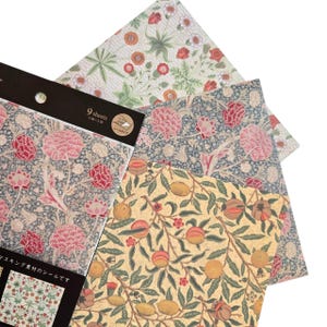May include: A selection of patterned paper sheets with floral and fruit designs. The sheets feature pink, red, and orange flowers, and yellow and green fruit. The text "9 sheets" is visible on a black label.