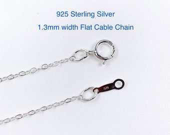 May include: A silver 925 sterling silver flat cable chain with a lobster clasp. The chain is 1.3mm wide.