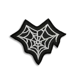 May include: Black fabric patch with a white embroidered spider web design.