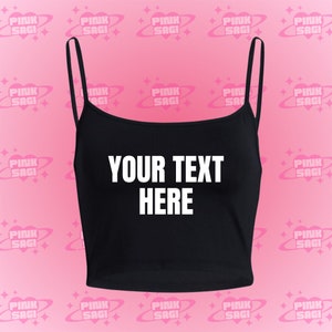 May include: Black crop top with adjustable straps and the text "YOUR TEXT HERE" printed in white on the front.