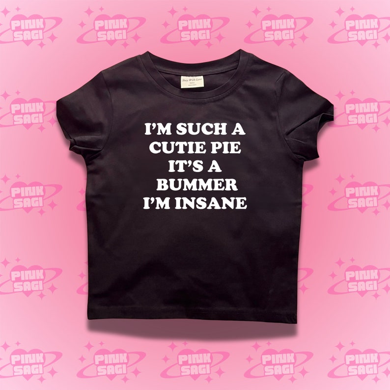May include: Black t-shirt with white text that reads "I'm such a cutie pie it's a bummer I'm insane."