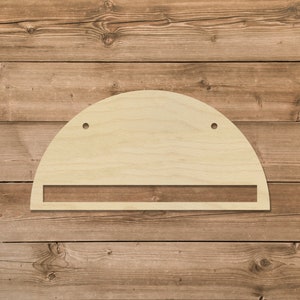 May include: A wooden half-circle shelf with a small rectangular shelf underneath. The shelf has two holes for hanging.