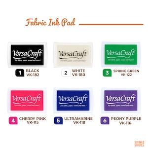 May include: A range of VersaCraft fabric ink pads in colours such as black, white, spring green, cherry pink, ultramarine, and peony purple. Each pad is labelled with its colour and product code, suitable for fabric, paper, wood, and more.