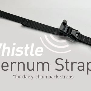 May include: Black sternum strap with a whistle buckle, designed for daisy-chain pack straps. The strap is made of a durable, woven material and features adjustable buckles for a secure fit. The text "Whistle Sternum Strap" is displayed.