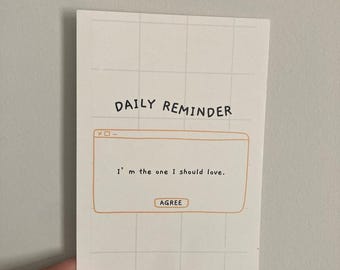 May include: A white card with a grid pattern and a pop-up window with the text "DAILY REMINDER" and "I'm the one I should love." with a button that says "AGREE".