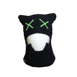 May include: Black crochet balaclava with green X's for eyes.