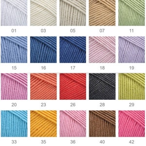 K&ouml;nnte beinhalten: Eine Farbkarte mit Garnkn&auml;ueln in verschiedenen Farbt&ouml;nen, darunter Hellblau, Creme, Beige und Gr&uuml;n. Die Karte zeigt eine Reihe von Farben, von Pastellt&ouml;nen bis hin zu leuchtenden Farbt&ouml;nen, mit Nummern, die den Code jeder Farbe angeben. Ideal f&uuml;r Strick- und H&auml;kelprojekte.